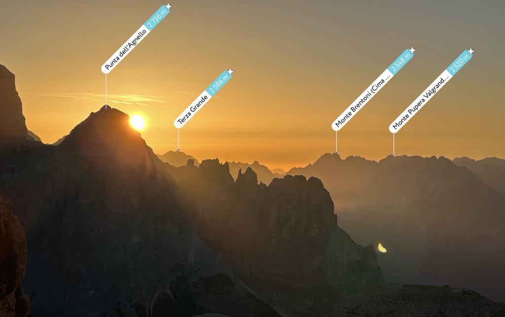 PeakVisor augmented reality labels over a sunrise in the mountains